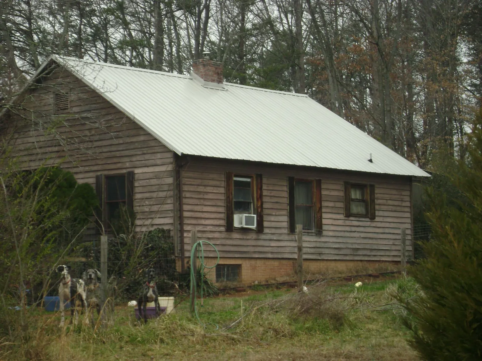 White metal roof on an old wood sided farmhouse, from a Metal Roof Installation job in Mount Solon